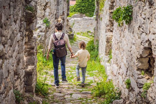 Dad and son tourists walks through the old town of Bar in Montenegro. Happy tourist walks in the mountains. Suburbs of the city of Bar, Montenegro, Balkans. Beautiful nature and landscape.