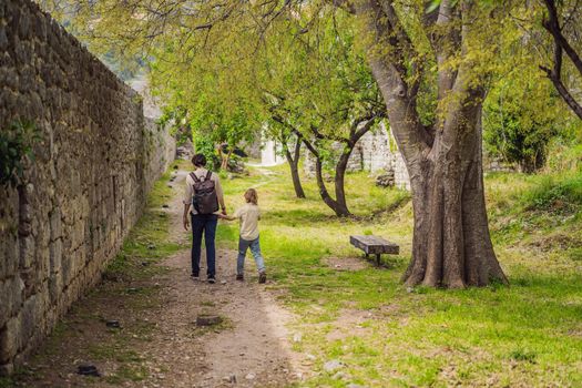 Dad and son tourists walks through the old town of Bar in Montenegro. Happy tourist walks in the mountains. Suburbs of the city of Bar, Montenegro, Balkans. Beautiful nature and landscape.