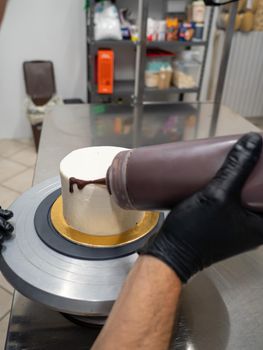 decorating a frosted cake with chocolate and nutella