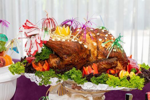 A large roast turkey on the holiday table at Thanksgiving.