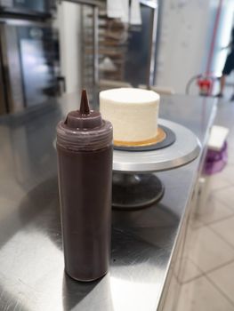 decorating a frosted cake with chocolate and nutella