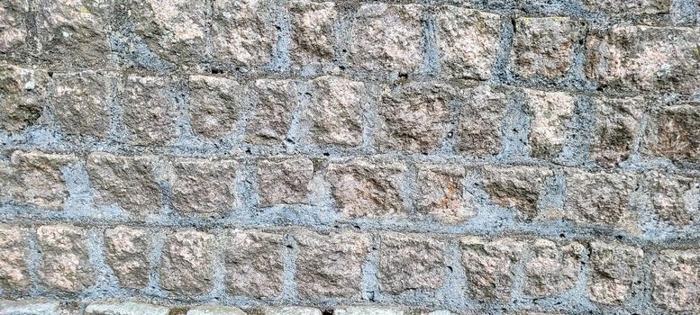 old brick wall of dark stones, which can be used as a background