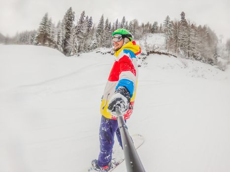Skier skiing downhill during cloudy day in high mountains.