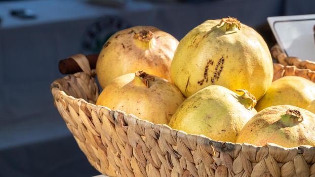 Green yellow grenades in a wicker basket close-up. High quality photo