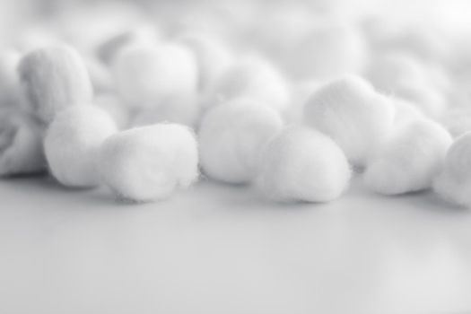 Cosmetology, branding and cleanliness concept - Organic cotton balls background for morning routine, spa cosmetics, hygiene and natural skincare beauty brand product as healthcare and medical design