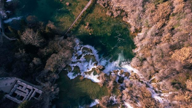 Drone bird eye view of of Krka National Park ,situated along the Krka River in southern Croatia. A series of 7 waterfalls. In the south, Skradinski Buk waterfall is flanked by traditional watermills.