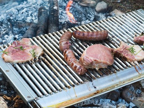 cooking pork meat in the grill outdoors with charcoal
