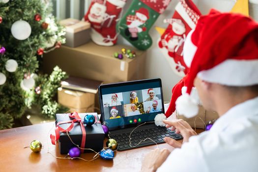 man at home christmas with santa claus hat with tablet.