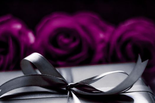 Luxurious design, shop sale promotion and happy surprise concept - Luxury holiday silver gift box and purple roses as Christmas, Valentines Day or birthday present