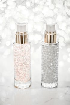 Cosmetic branding, blank label and glamour present concept - Holiday make-up base gel, serum emulsion, lotion bottle and silver glitter, luxury skin and body care cosmetics for beauty brand ads