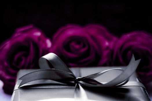 Luxurious design, shop sale promotion and happy surprise concept - Luxury holiday silver gift box and purple roses as Christmas, Valentines Day or birthday present