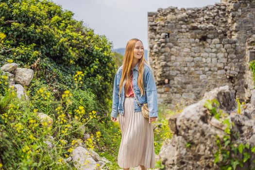 Woman tourist walks through the old town of Bar in Montenegro. Happy tourist walks in the mountains. Suburbs of the city of Bar, Montenegro, Balkans. Beautiful nature and landscape.
