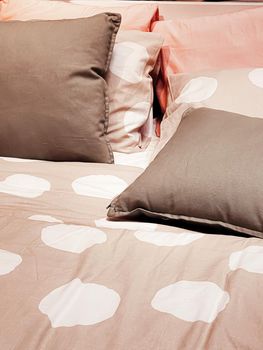 Modern style bedding on bed in bedroom, interior design detail