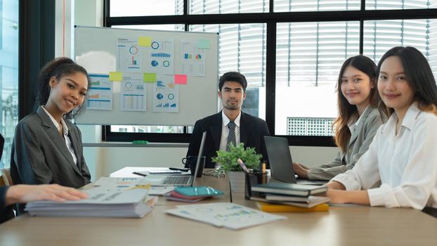 Analytics intelligence concept. Group of business people discuss current financial and economic on laptop for investment at the meeting.