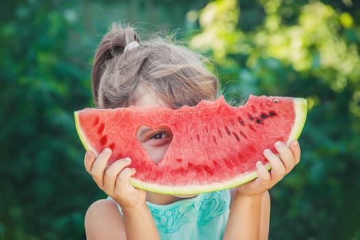 A child eats watermelon. Selective focus. nature.