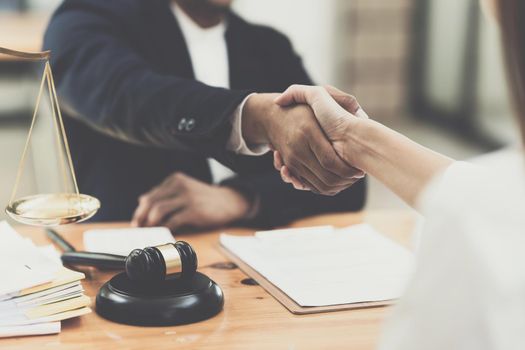 Business person and lawyer shaking hand after discussing about agreement contract. Law, legal services, advice, Justice concept.