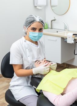 Dentist looks at a jaw of female patient. Showing the bite to the doctor