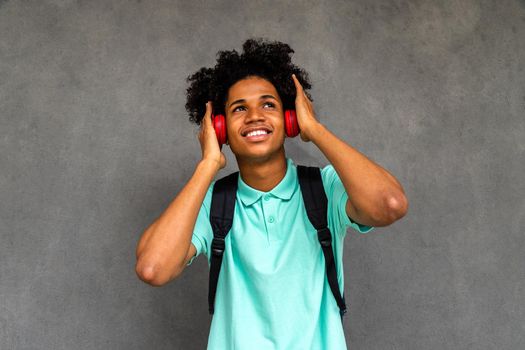 African American male teenager listens to music with headphones. Lifestyle concept.