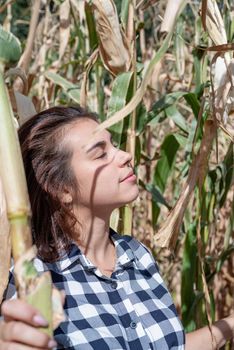 agriculture and cultivation concept. Countryside. Cheerful caucasian woman in the corn crop, shadow overlay on face