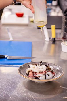 Chef seasoning seafood in restaurant kitchen.Fresh nutrition