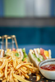 Club sandwich with french fries with pepper sos .fast cuisine