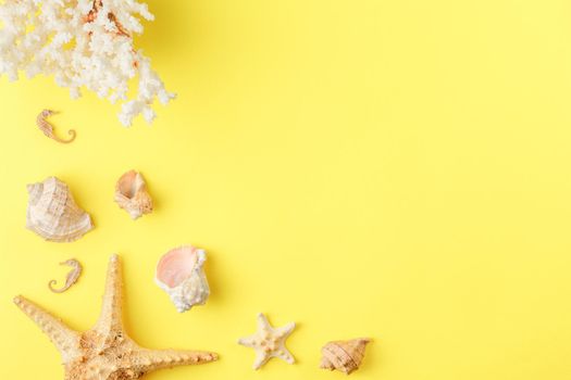 Seashells and starfish on yellow isolated background. Top view. Sandy beach concept. Corals and seahorses. Flat lay.