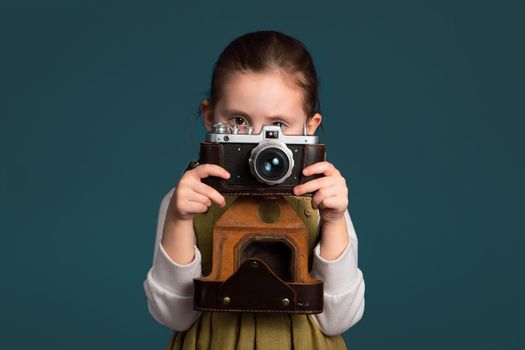 Cute little girl is serious about the art of photography.