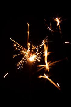 Real sparkler with sparks on black background for overlay blending mode.