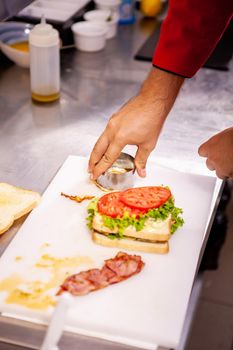 Chef making sandwich with fresh ingredient.Delicious nutrition