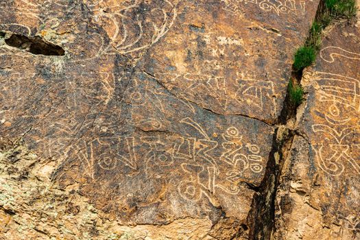 Ancient inscriptions on the rock in Sanskrit. open air buddhist temple.