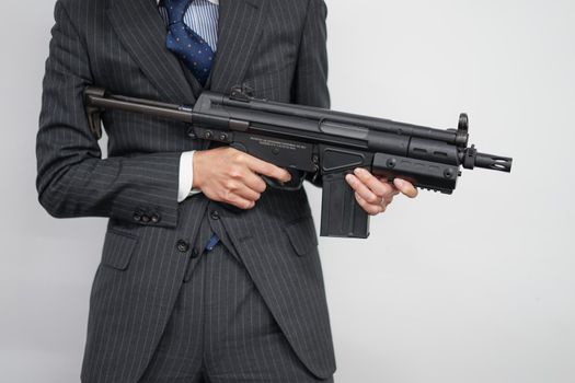 Fight businessman with machine gun. Shooting Location: Tokyo metropolitan area