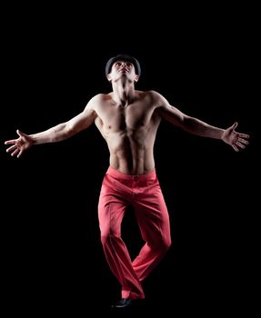 young athletic naked man dance striptease in red costume