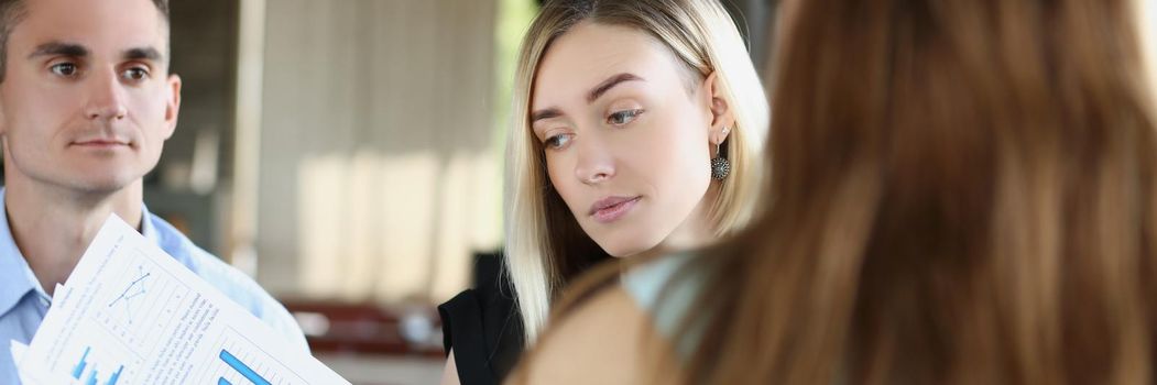 Portrait of business partners discuss report or contract on meeting in cafe outdoors, businesspeople listen to employee. Business, career, strategy concept