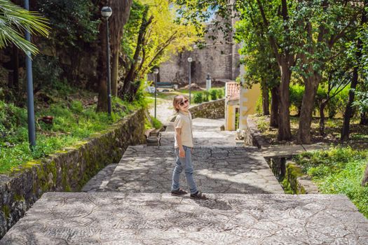 Boy tourist in Herceg Novi old town. Historical and touristic center of Herceg Novi. Montenegro.