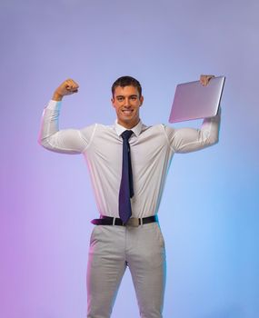 Businessman bodybuilder with a laptop in his hands