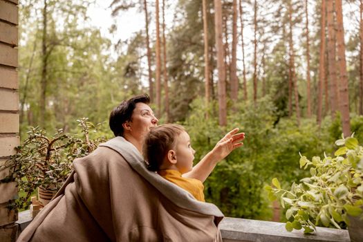 Happy grandmother and grandson enjoy time together. Positive middle age woman spending time with little, cute grandchild, having fun. 50-year-old grandma with grandkid. Multi-generational family