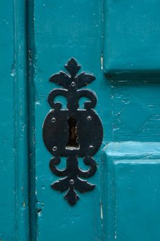 Blue handle door rusty iron handle in wood doorway