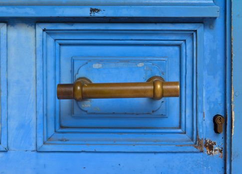Blue handle door rusty iron handle in wood doorway