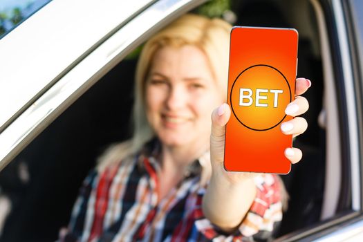 woman makes bets on smartphone.