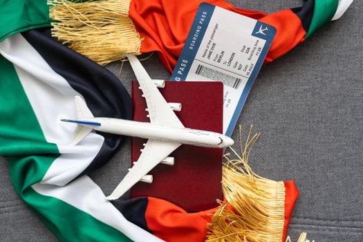 Passport and a United Arab Emirates flag on a gray background. Travel concept.