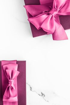 Birthday, wedding and girly branding concept - Pink gift box with silk bow on marble background, girl baby shower present and glamour fashion gift for luxury beauty brand, holiday flatlay art design