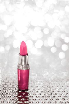 Cosmetic branding, sale and glamour concept - Pink lipstick on silver Christmas, New Years and Valentines Day holiday glitter background, make-up and cosmetics product for luxury beauty brand