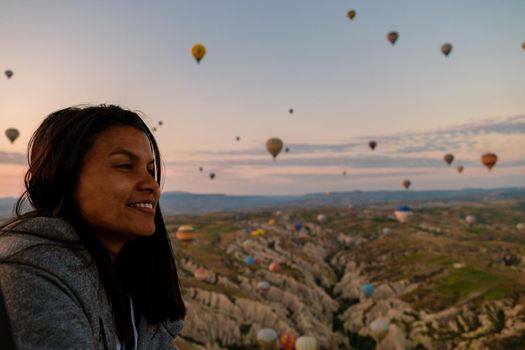 Asian women in a hot air balloon during sunrise in Cappadocia Turkey. Kapadokya Gorem. Happy mid age women in a hot air balloon