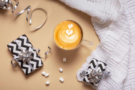 Christmas hugge flat lay composition with gifts, paper balls, plaid and coffee cup top view.