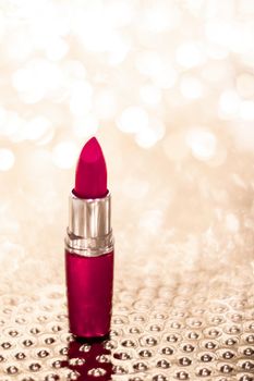 Cosmetic branding, sale and glamour concept - Maroon lipstick on golden Christmas, New Years and Valentines Day holiday glitter background, make-up and cosmetics product for luxury beauty brand