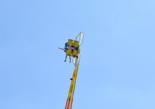 two people in a park on a catapult with a Blue Sky