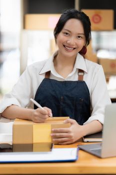 Asian small business owner working at home office. Business retail market and online sell marketing delivery, SME e-commerce concept.