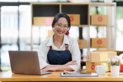 Asian small business owner working at home office. Business retail market and online sell marketing delivery, SME e-commerce concept.