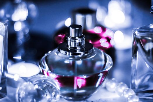 Perfumery, cosmetics branding and luxe concept - Perfume bottle and vintage fragrance on glamour vanity table at night, pearls jewellery and eau de parfum as holiday gift, luxury beauty brand present