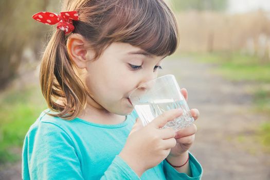 child glass of water. selective focus. Kids.